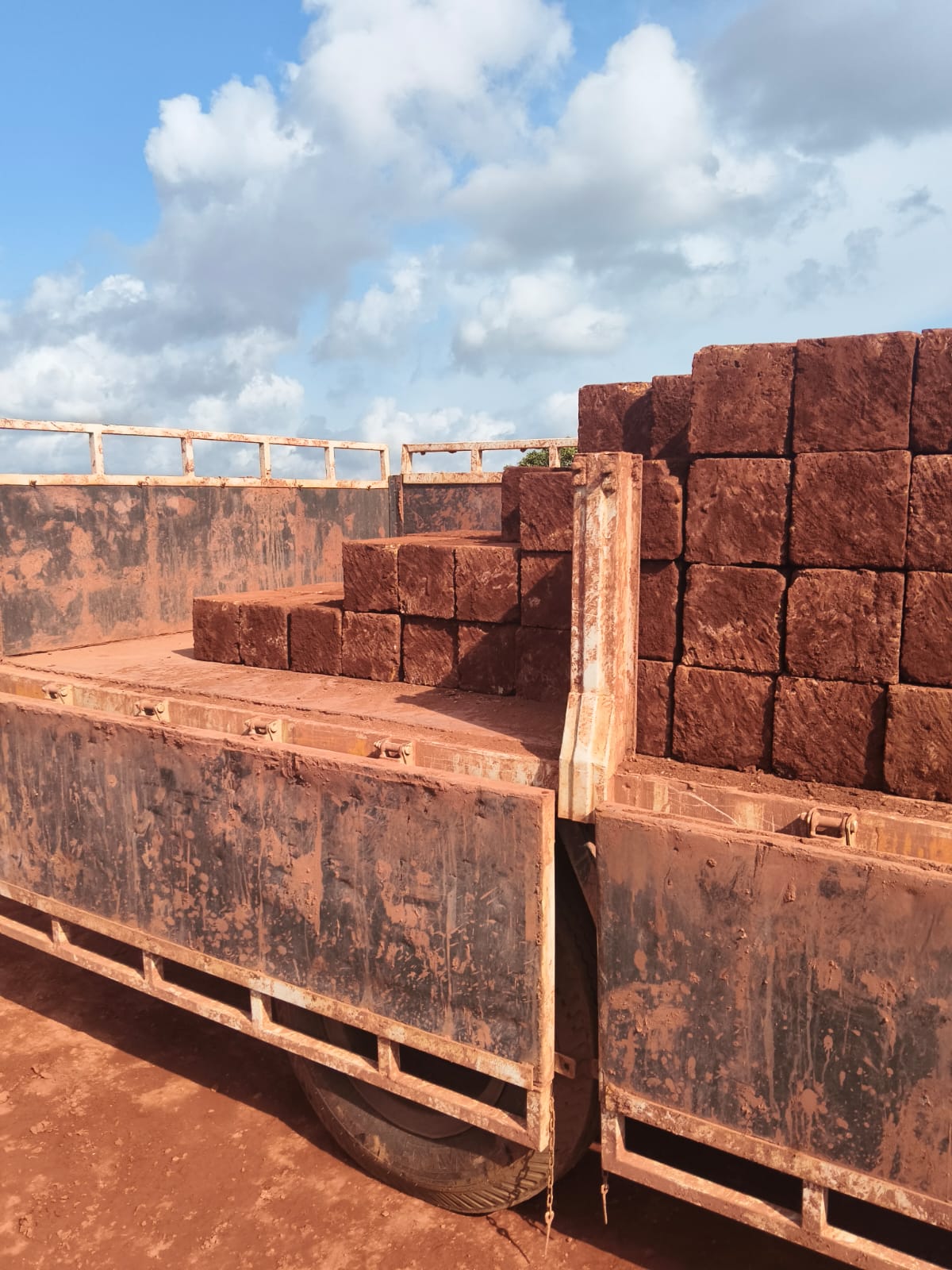 Uniform laterite stone blocks stacked on a delivery lorry