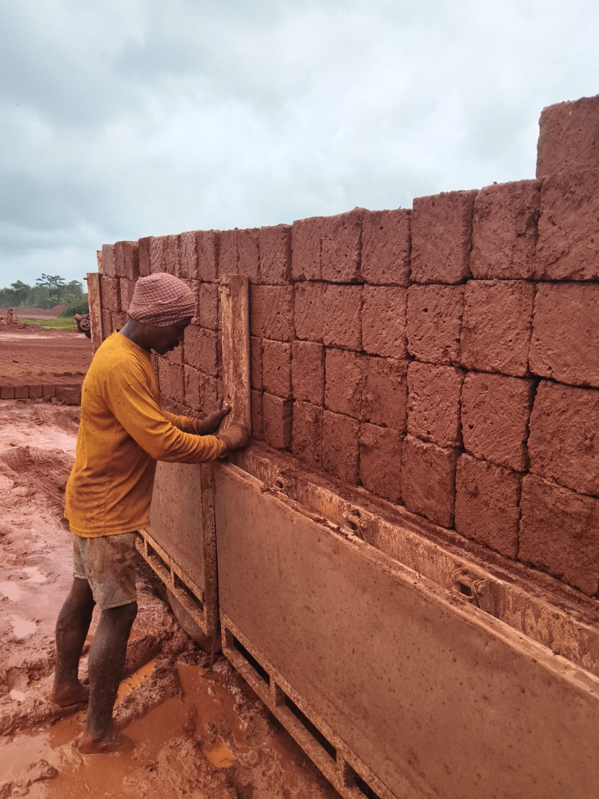 Worker loading laterite stone blocks